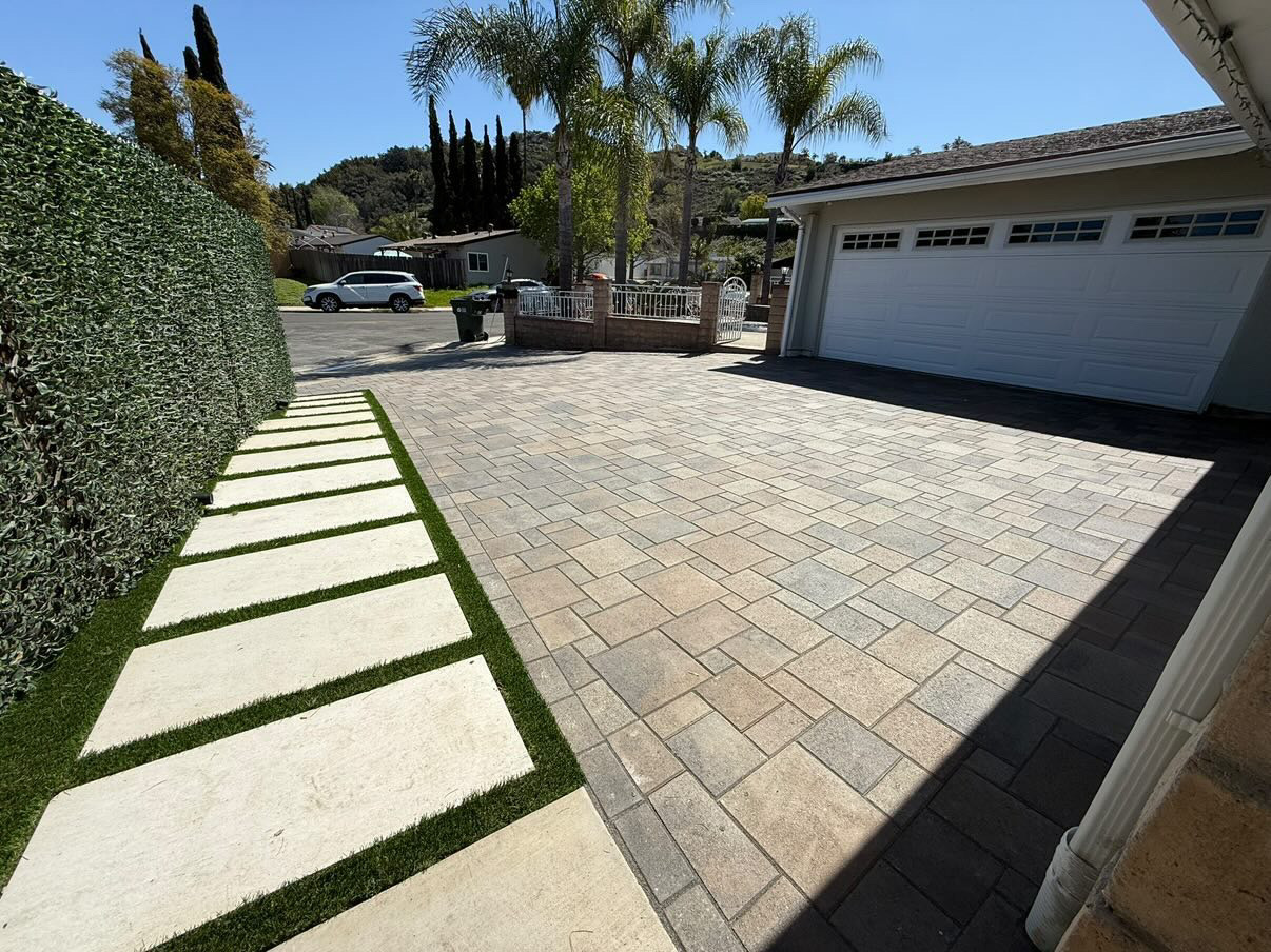 Paver driveway with stepping stone walkway and turf