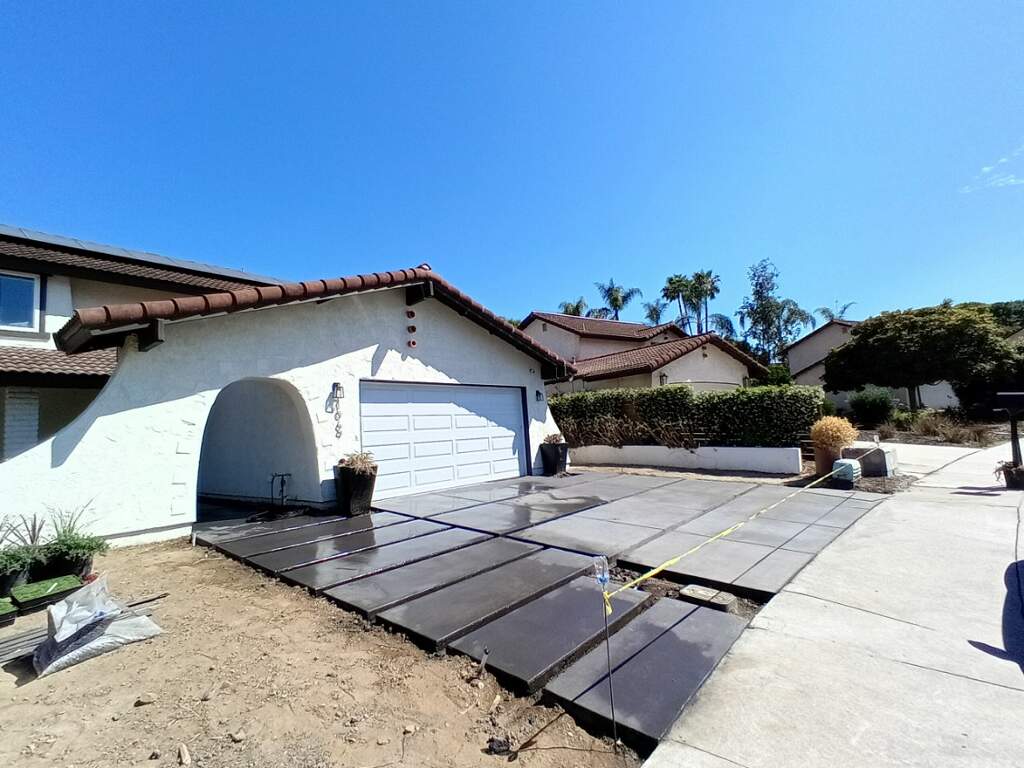 Dark concrete driveway installation